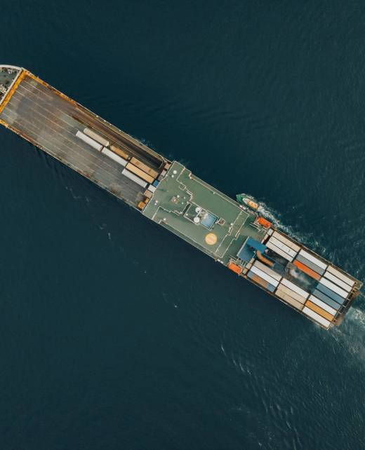 An aerial view of a Cargo ship in the blue sea